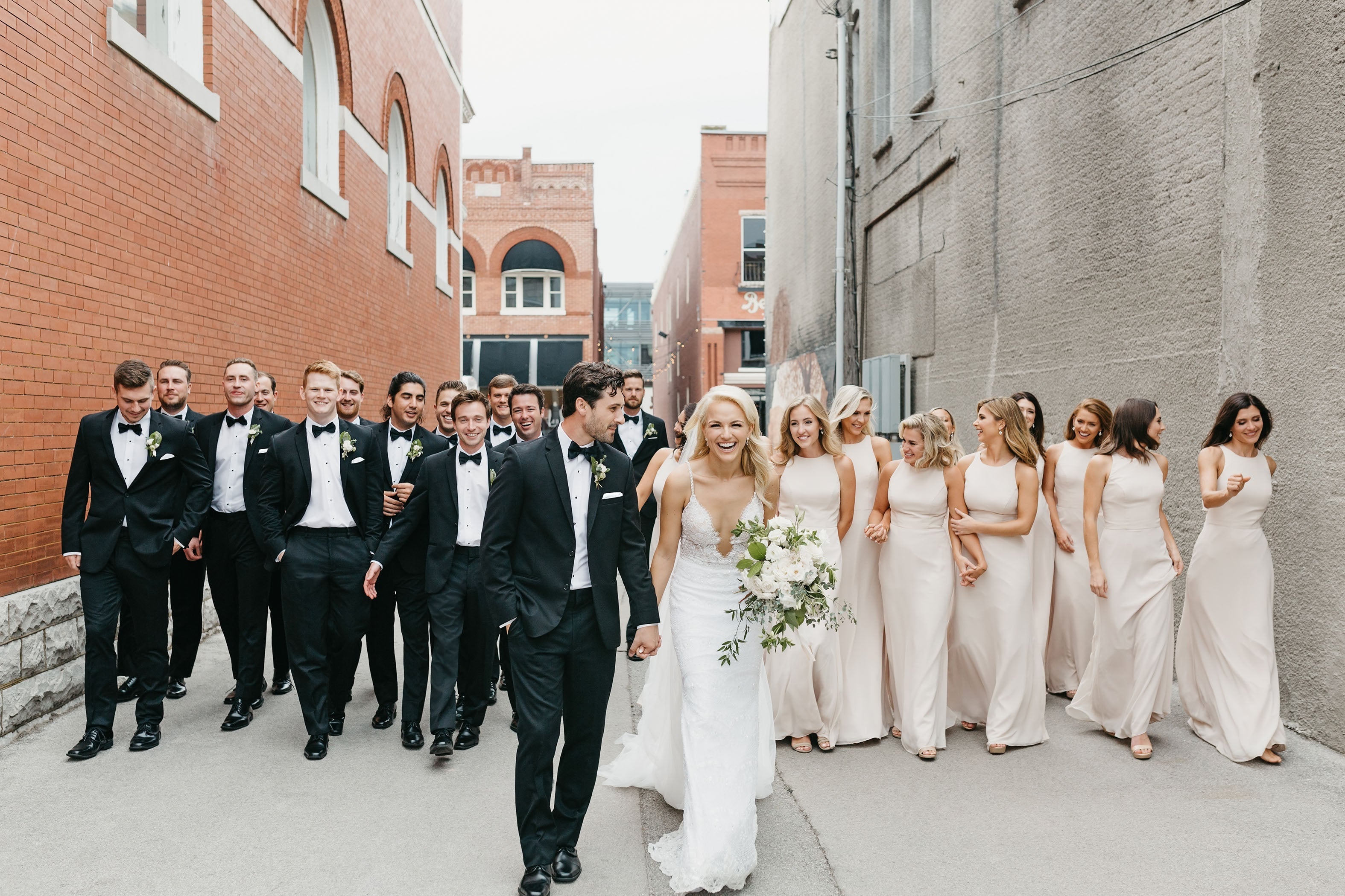 Man wearing a black tuxedo beside another in a navy suit, both dressed for a formal event. Let me know if you'd like a version tailored to a different image or another post.