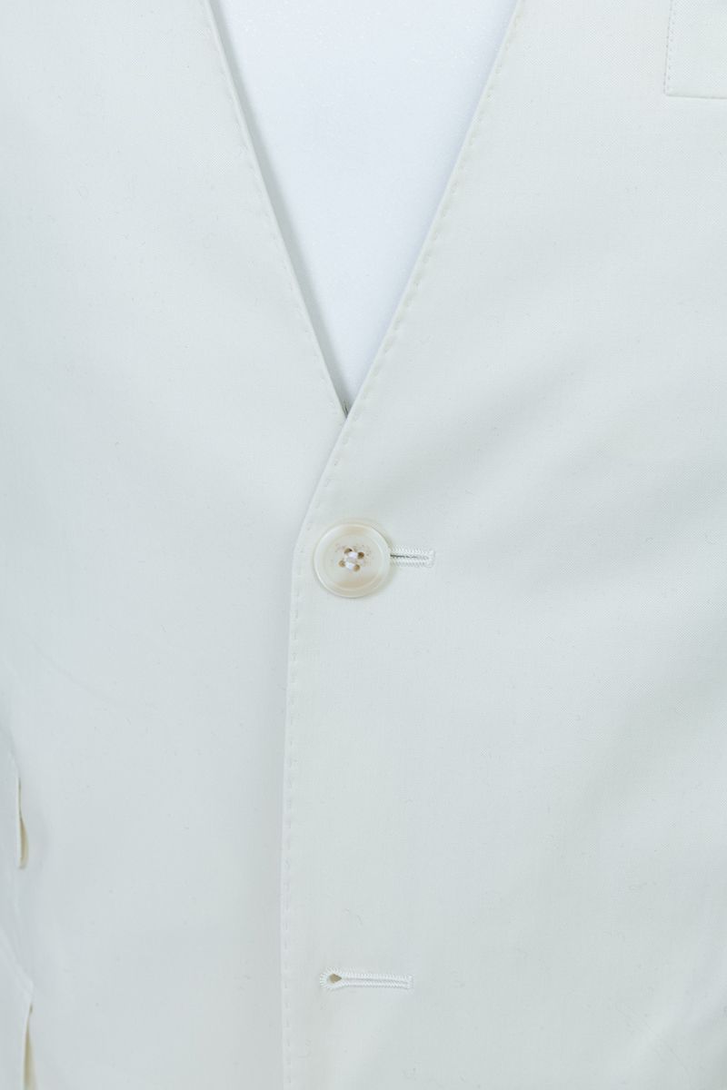Chest and peak lapel detail of the Salvatore Ivory Peak Lapel Blazer, a made-to-order men's ivory wedding blazer in premium stretch cotton, shipped nationwide by Zane.
