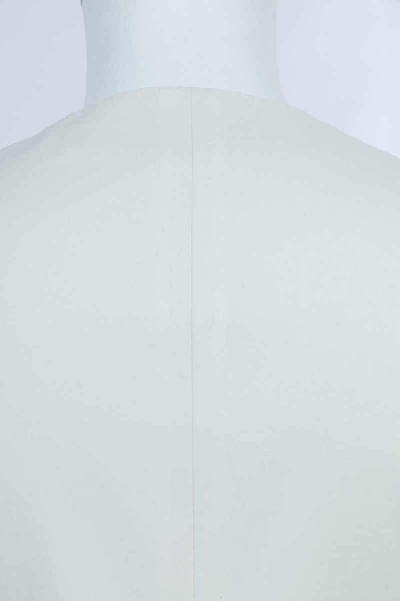 Cuff and button detail of the Salvatore Ivory Peak Lapel Blazer, a made-to-order men's ivory blazer in premium stretch cotton, tailored to your measurements and shipped nationwide by Zane.