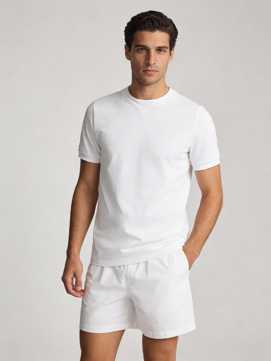 Man wearing white 100% cotton made to order crew neck tee with stitched V insert neckline, shipped nationwide by Zane