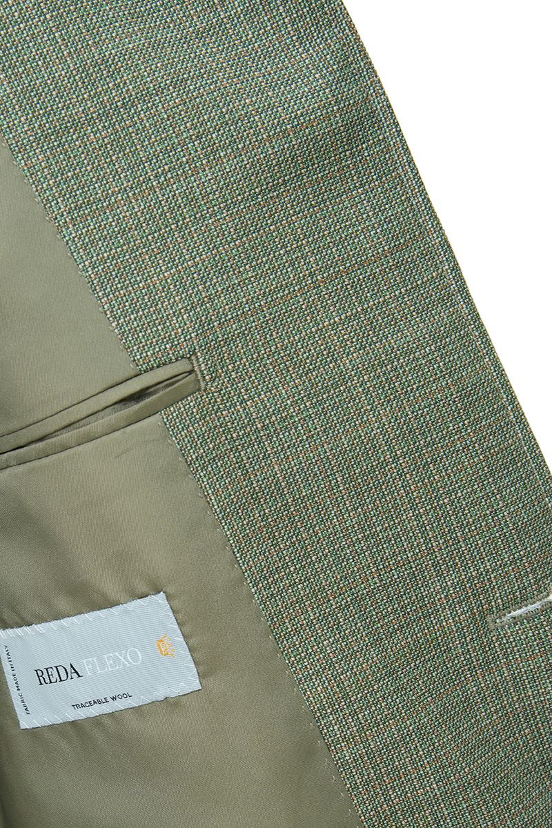Studio portrait of the Marco Sage Green Mandarin Collar Jacket, a made-to-order men's Mandarin collar jacket in sage green Super 130s Italian REDA wool, shipped nationwide by Zane.