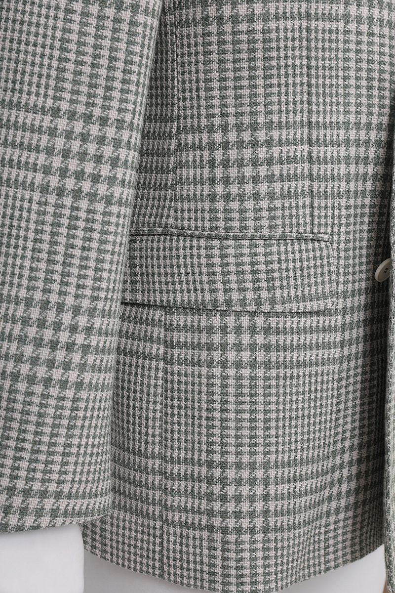 Chest and peak lapel detail of the Raffaele Grey Glen Plaid Double Breasted Sport Coat, a made-to-order men's jacket in an Italian Marzotto cotton-wool blend, shipped nationwide by Zane.