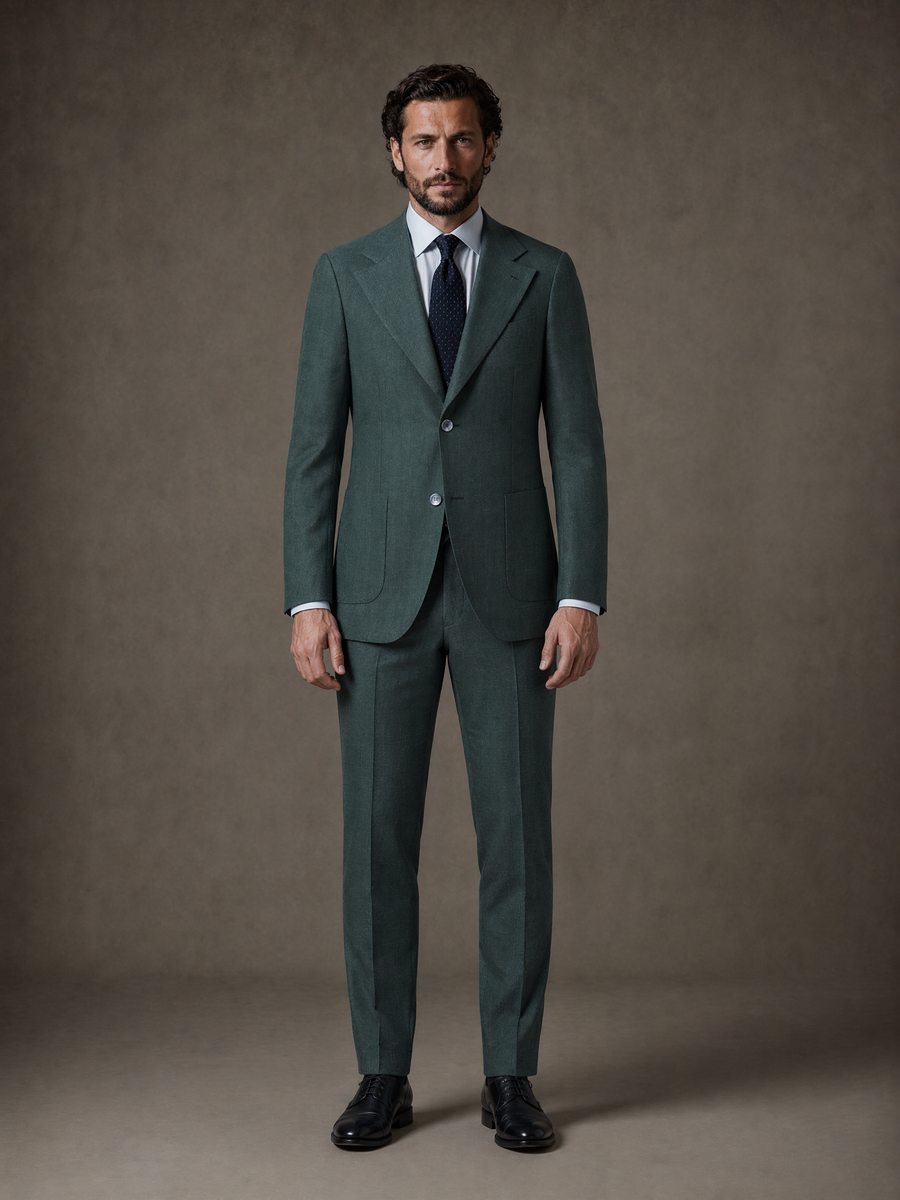 Full-length studio photograph of the Fabio Pine Green Linen Sport Coat, a made-to-order men's sport coat in 100% Italian linen by Guabello, pine green with a natural linen texture and notch lapel, tailored to your measurements for summer weddings and warm-weather events and shipped nationwide by Zane.