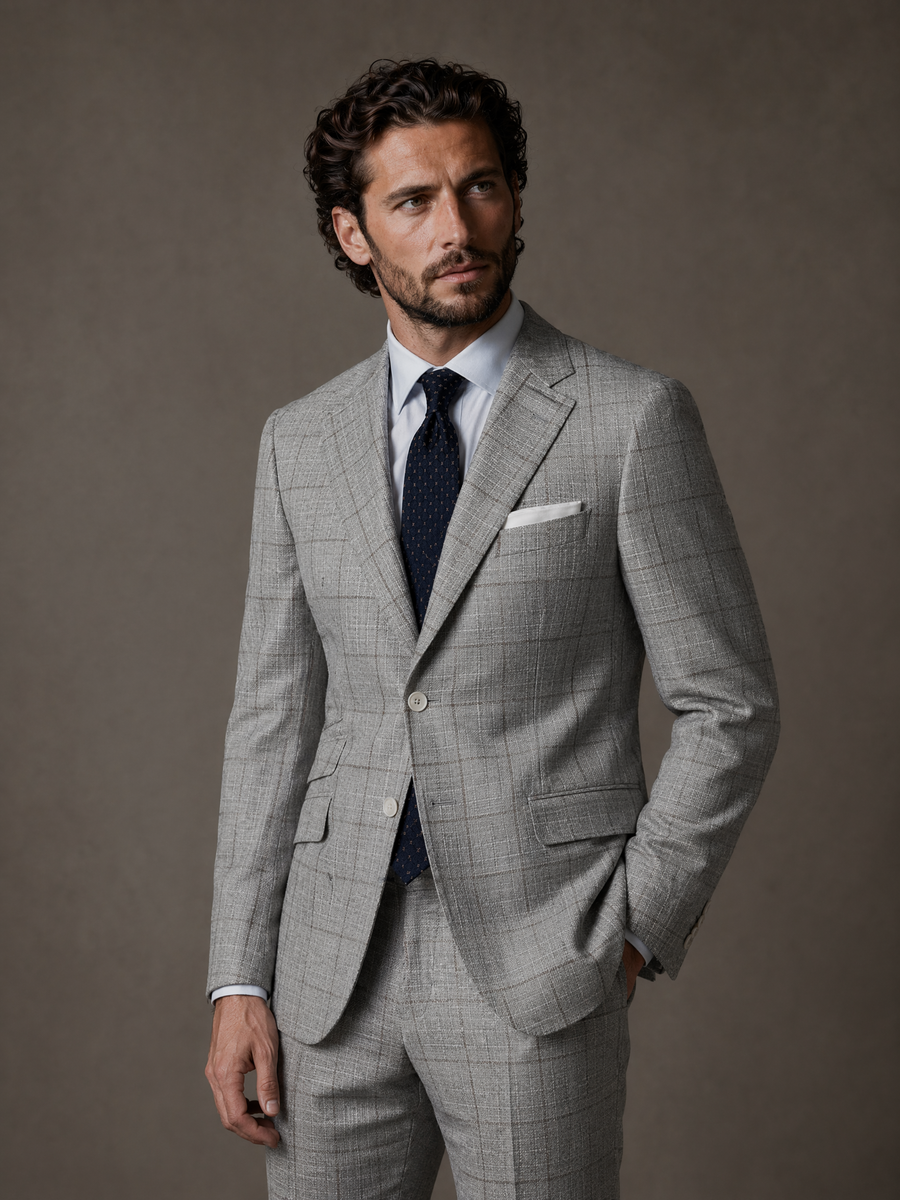 Full-length studio photograph of the Dante Light Grey Windowpane Sport Coat, a made-to-order men's sport coat in an Italian cotton, linen, and wool blend by Guabello, light grey with a subtle windowpane check and notch lapel, tailored to your measurements for business and warm-weather events and shipped nationwide by Zane.