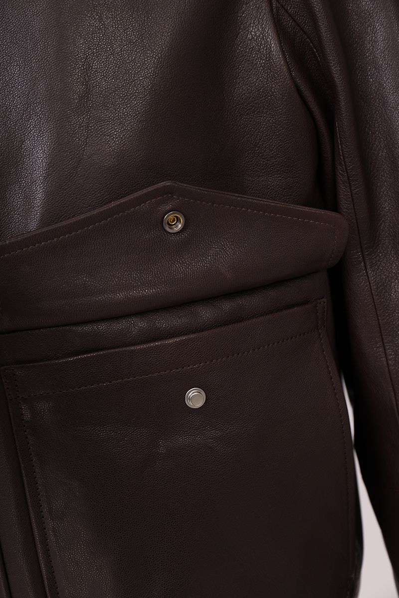 Brown leather flight jacket collar worn open