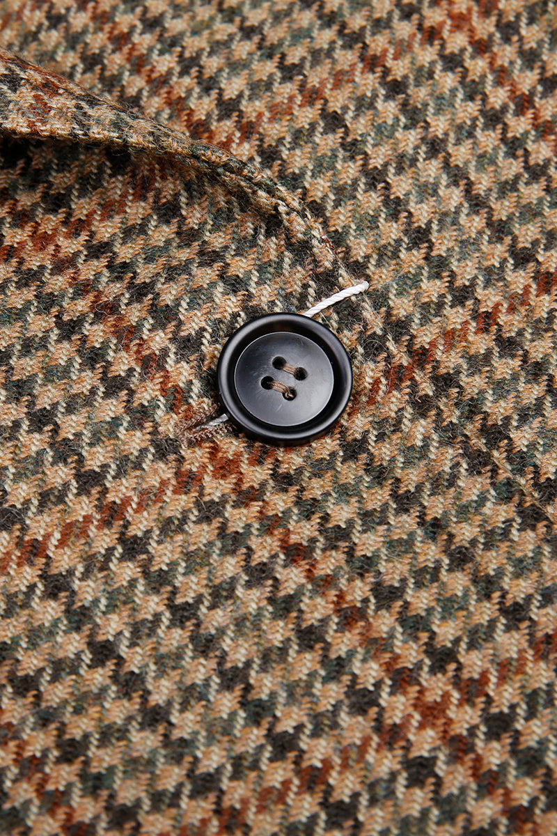 Close-up of a button on a houndstooth patterned fabric bespoke overcoats for her
