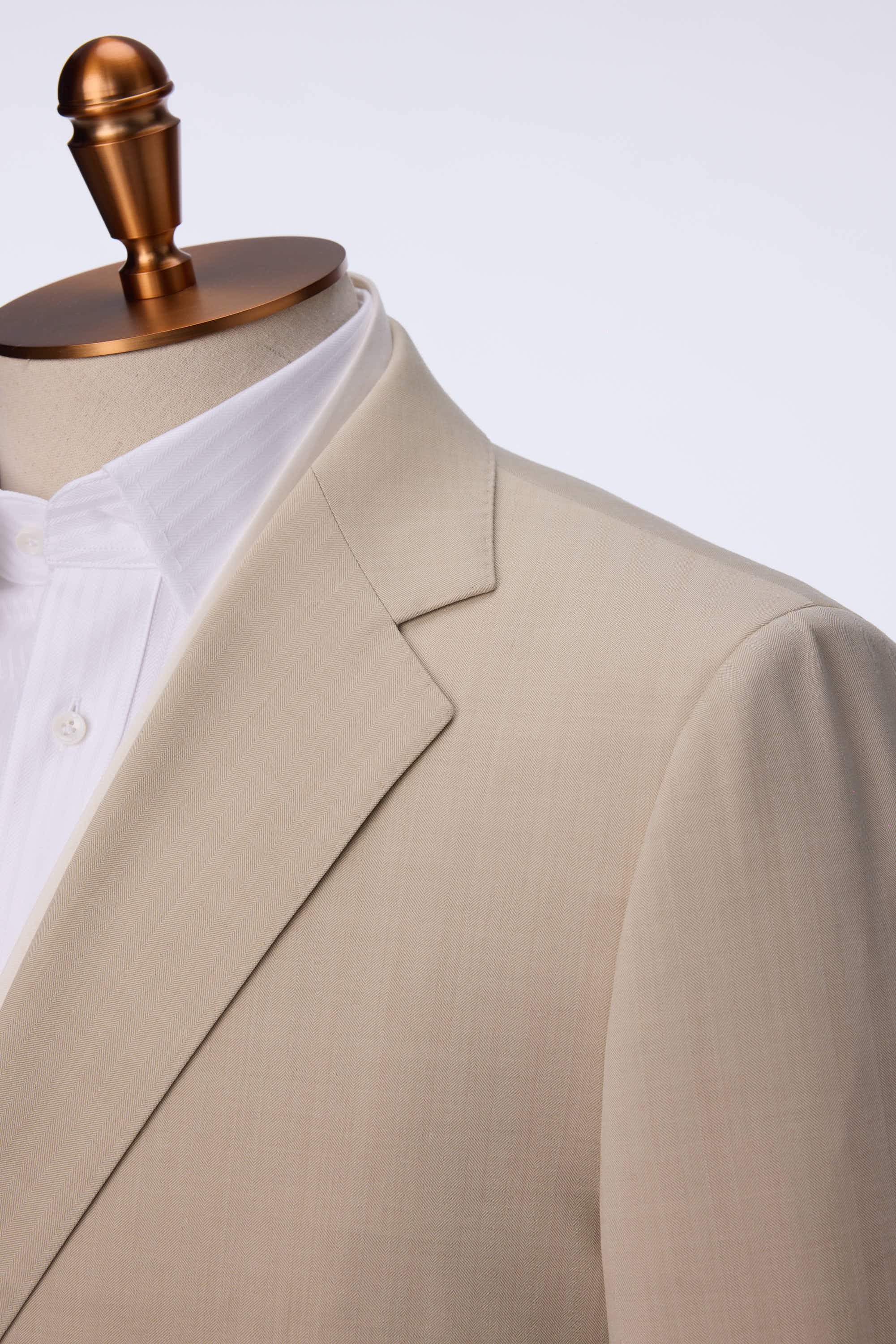 Crafted from 100% wool, this two-piece suit redefines business attire with a modern twist. The jacket features a double placket collar with a removable concept and an oblique placket design that enhances the silhouette with a fluid, cohesive shape. The subtle color block effect between white and khaki adds a refined softness, balancing contemporary style with traditional tailoring. Paired with matching trousers, this suit delivers a polished look for professional meetings, semi-formal events, or upscale soc