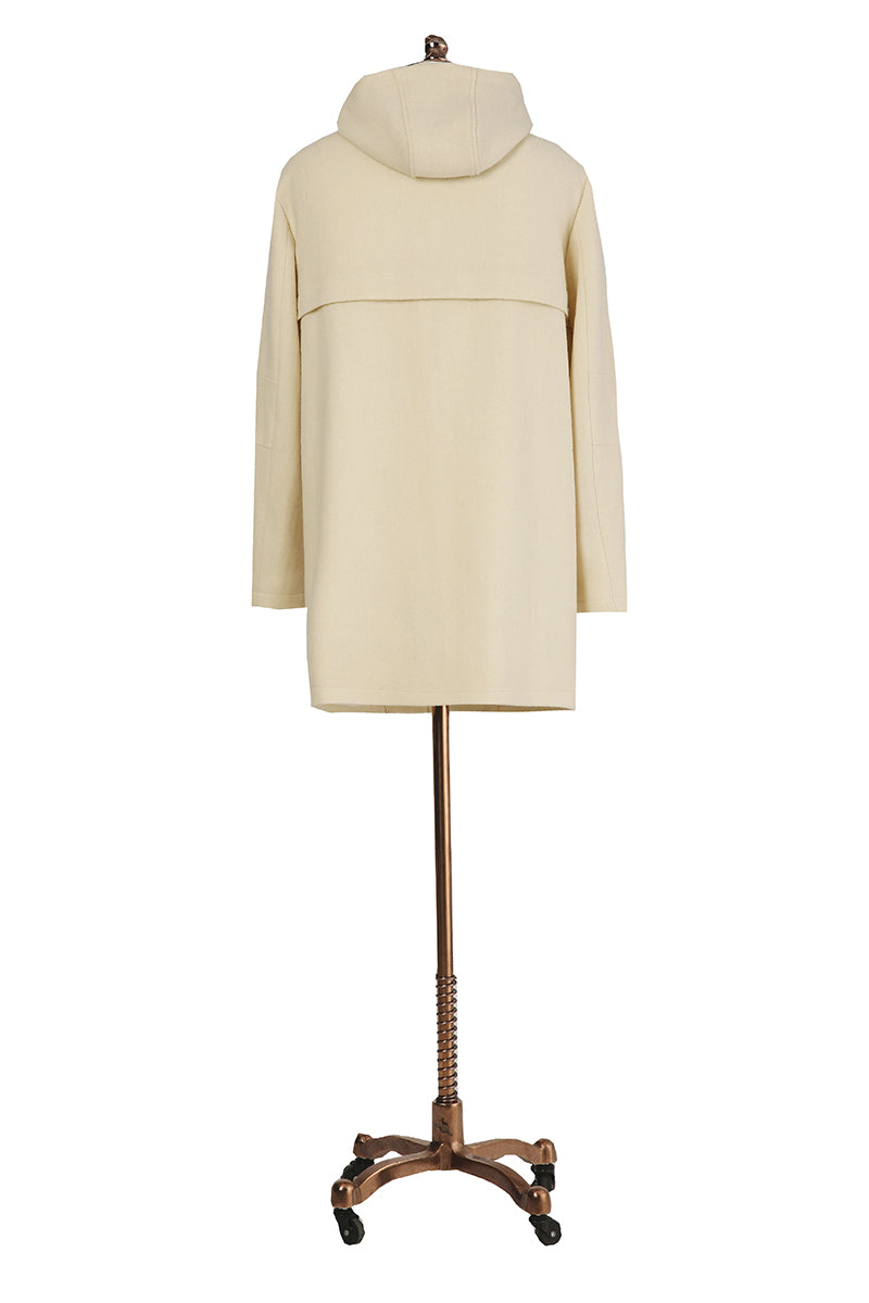 Beige coat on a mannequin against a white background