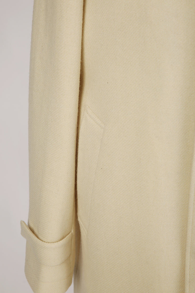 Close-up of beige pants with a plain background