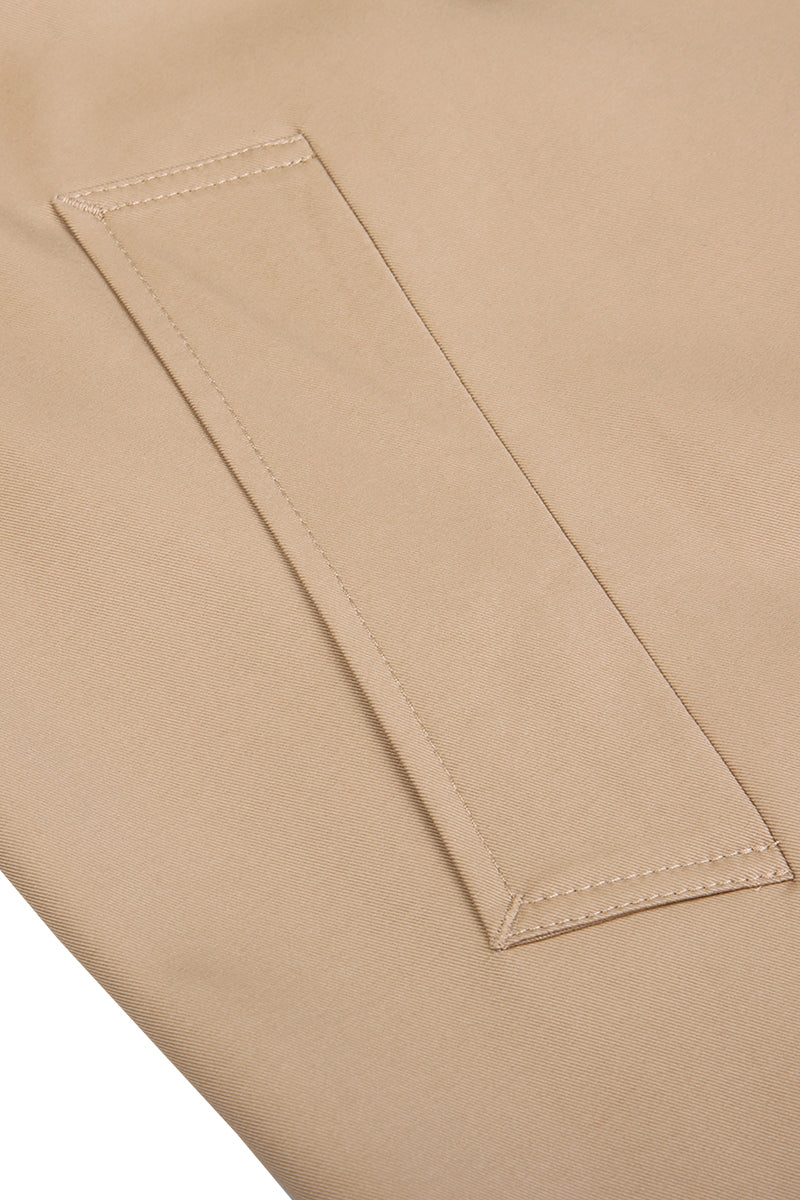 Close-up of a beige fabric pocket with stitching detail.