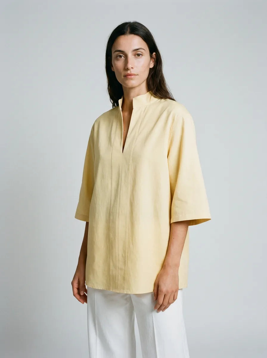 Woman wearing a light yellow blouse c ustom clothing for women