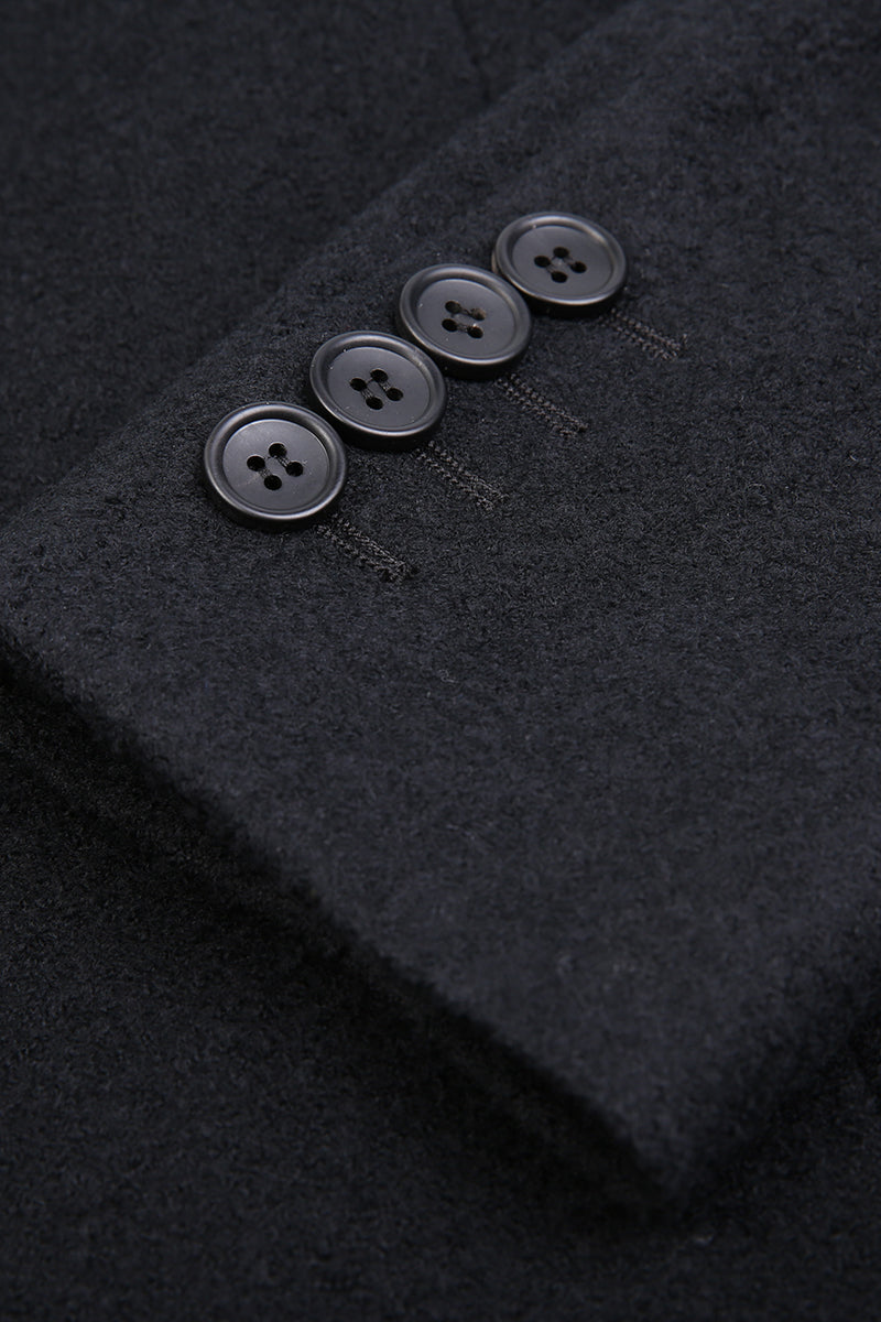 Close-up of a dark gray fabric with buttons on a textured background