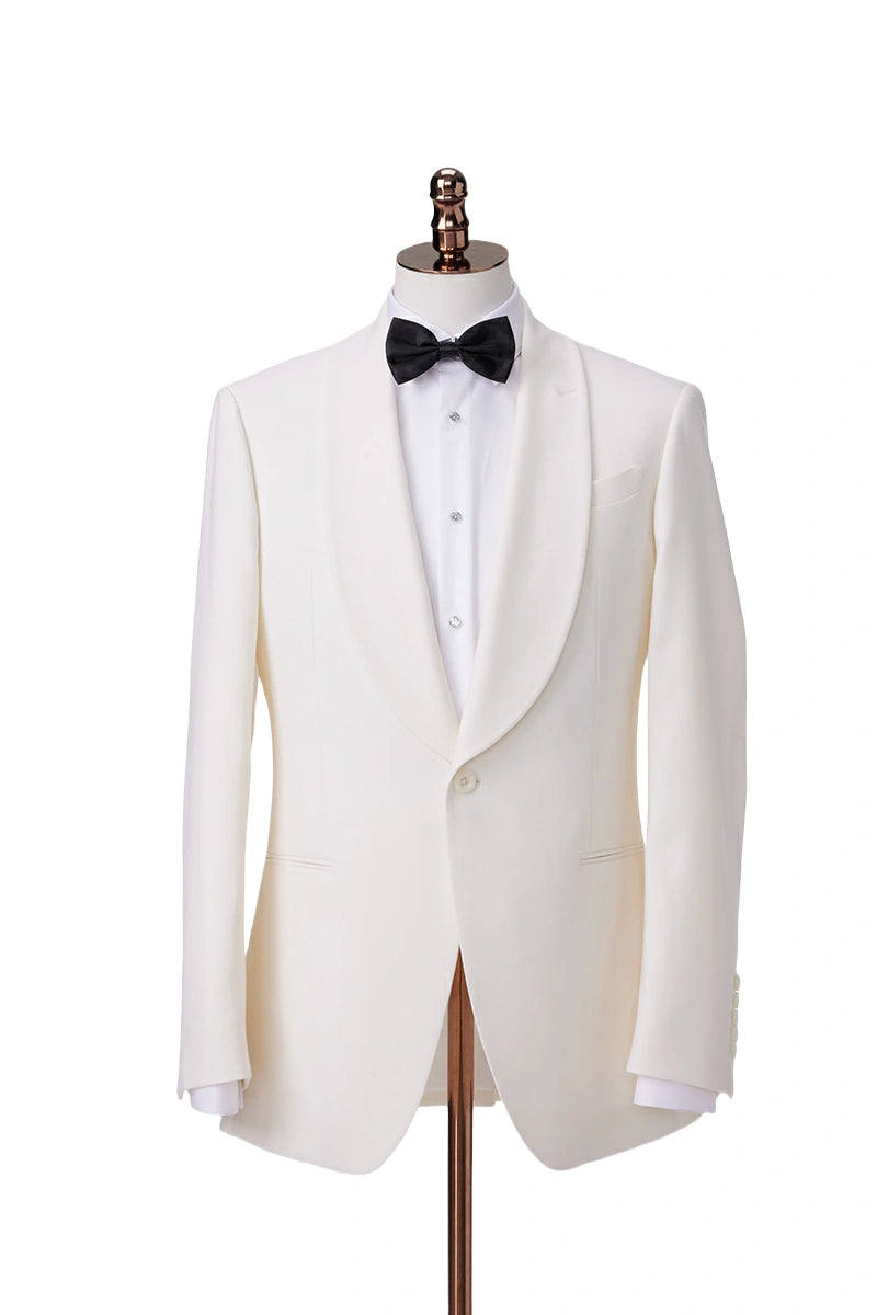 An ivory tuxedo on a mannequin, featuring a jacket with a single-button closure and a shawl collar, paired with matching flat-front trousers.