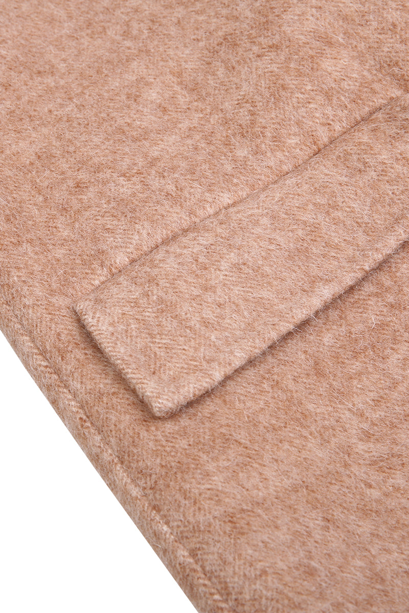 Close-up of a textured beige fabric with a subtle pattern