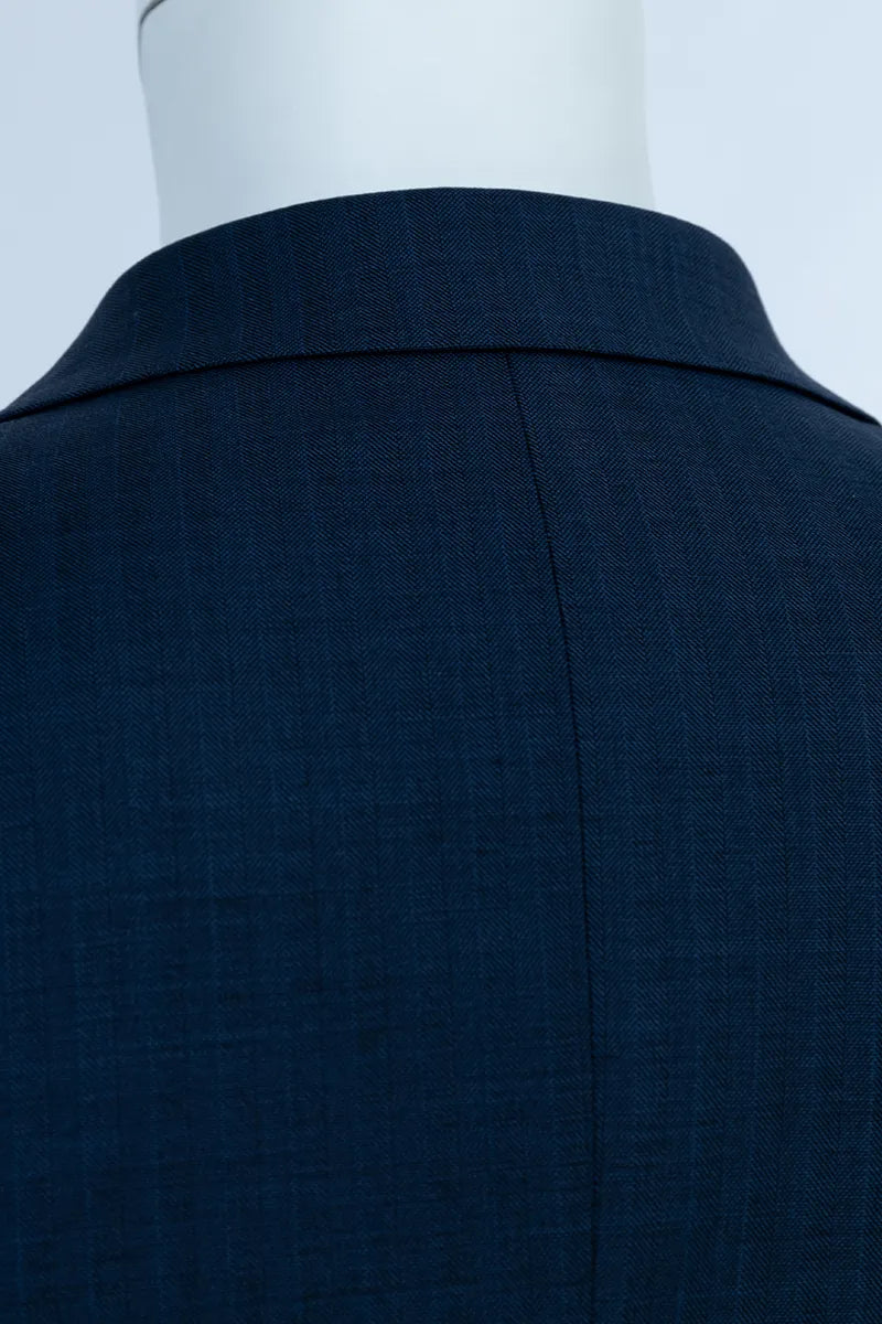 Navy blue suit jacket on a mannequin with a plain background