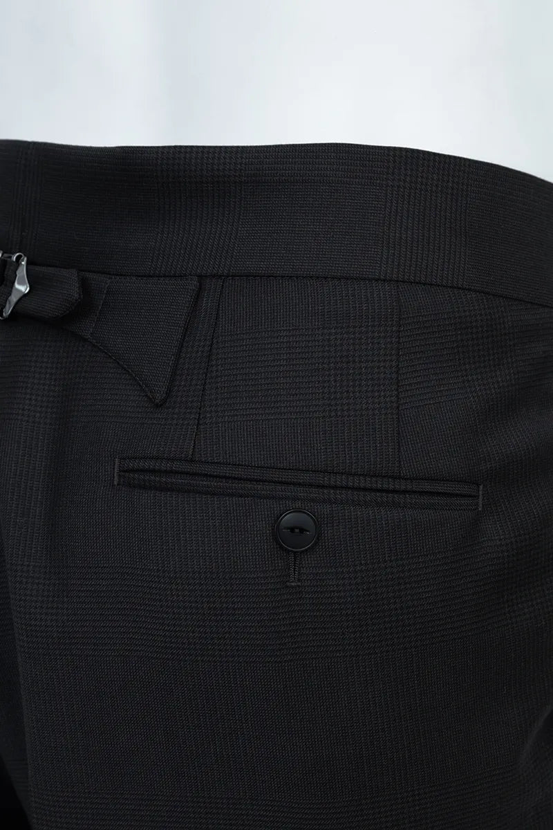 Close-up of a black suit pocket with a button on a white background