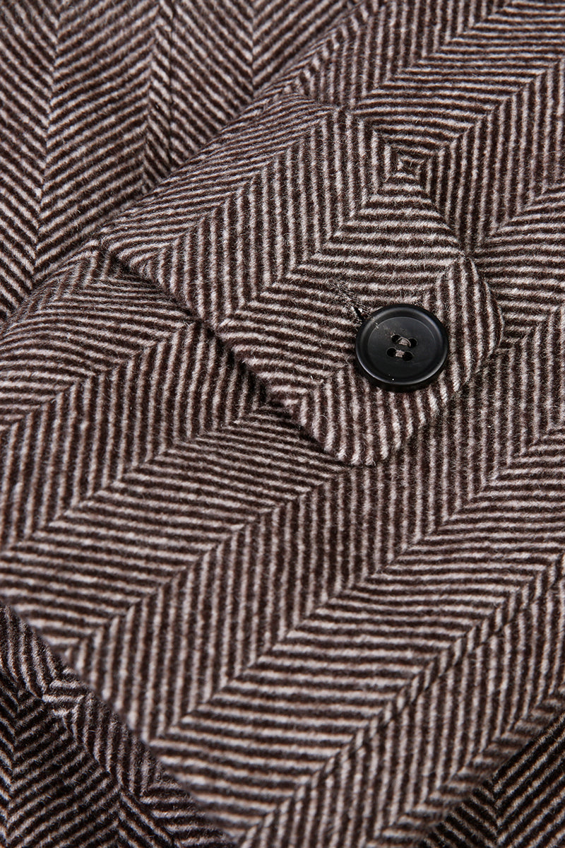 Close-up of a herringbone patterned fabric with a button.