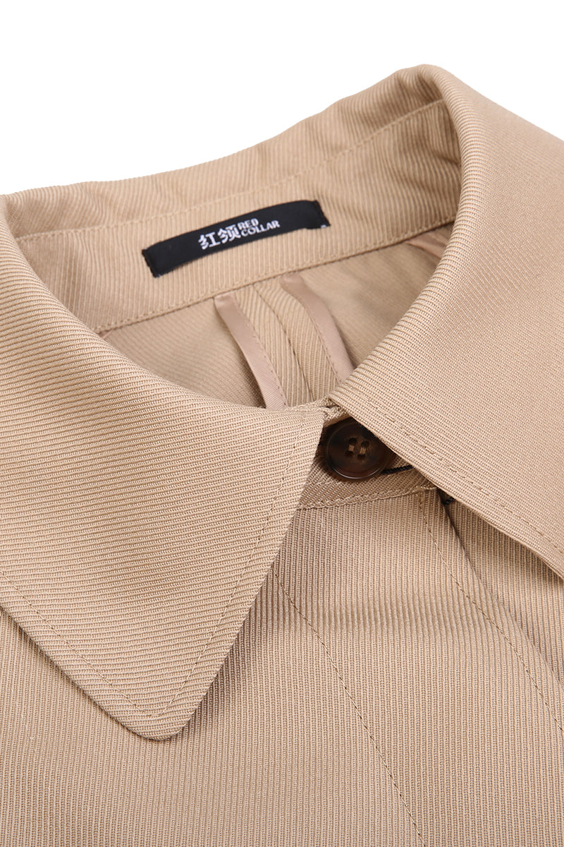 Close-up of a beige corduroy shirt collar with a brand label.
