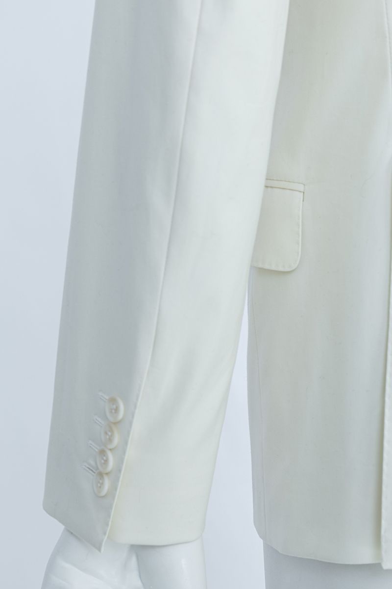 Studio portrait of the Salvatore Ivory Peak Lapel Blazer, a made-to-order men's peak lapel wedding blazer in ivory premium stretch cotton, shipped nationwide by Zane.
