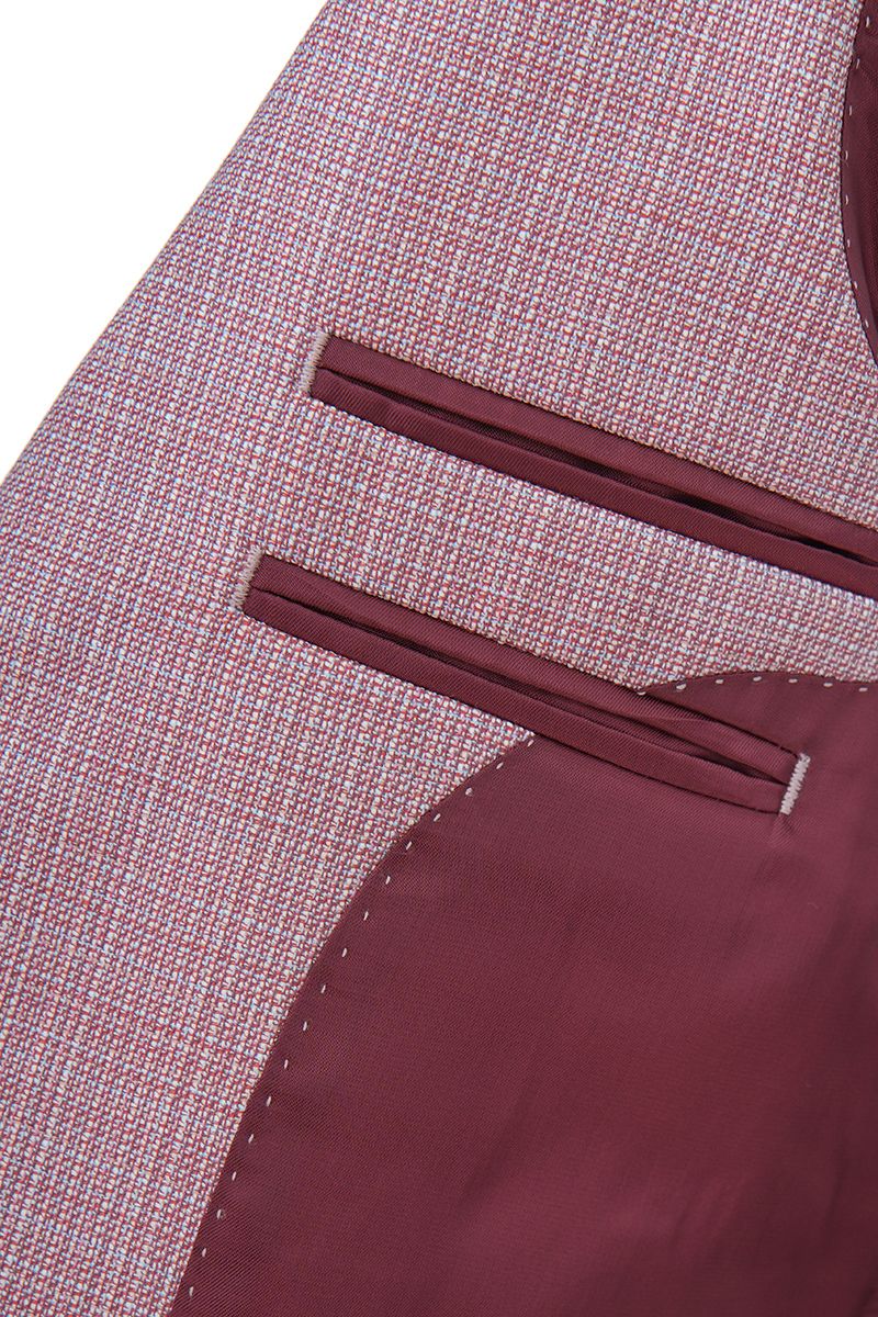 Studio portrait of the Enzo Dusty Pink Sport Coat, a made-to-order men's notch lapel jacket in dusty pink Super 130s Italian REDA wool, shipped nationwide by Zane.