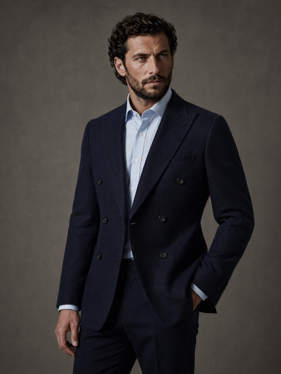 Full-length studio photograph of the Luca Navy Double Breasted Sport Coat, a made-to-order men's double-breasted sport coat in premium Italian REDA wool, navy with a fine textured weave and peak lapels, tailored to your measurements for business and evening events and shipped nationwide by Zane.