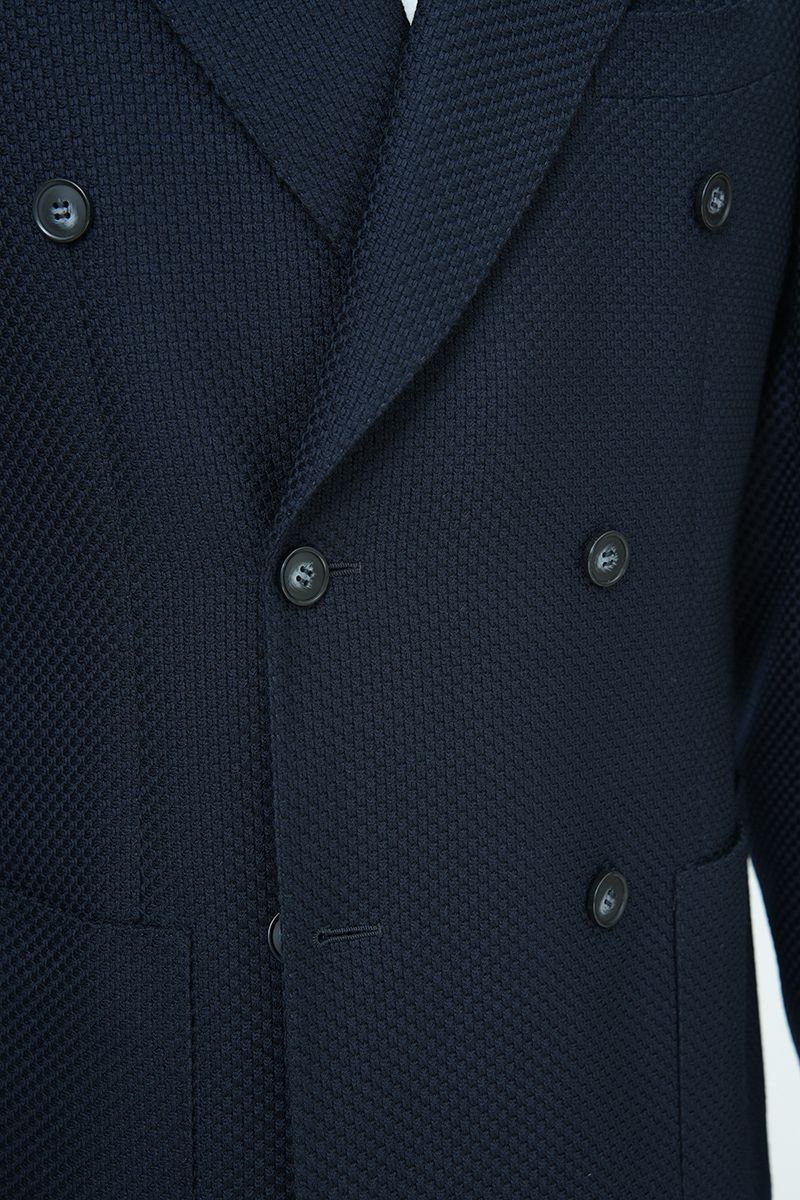 Fabric and tailoring close-up of the Luca Navy Double Breasted Sport Coat, showing the premium Italian REDA wool with a fine textured weave, made to order and shipped nationwide by Zane.