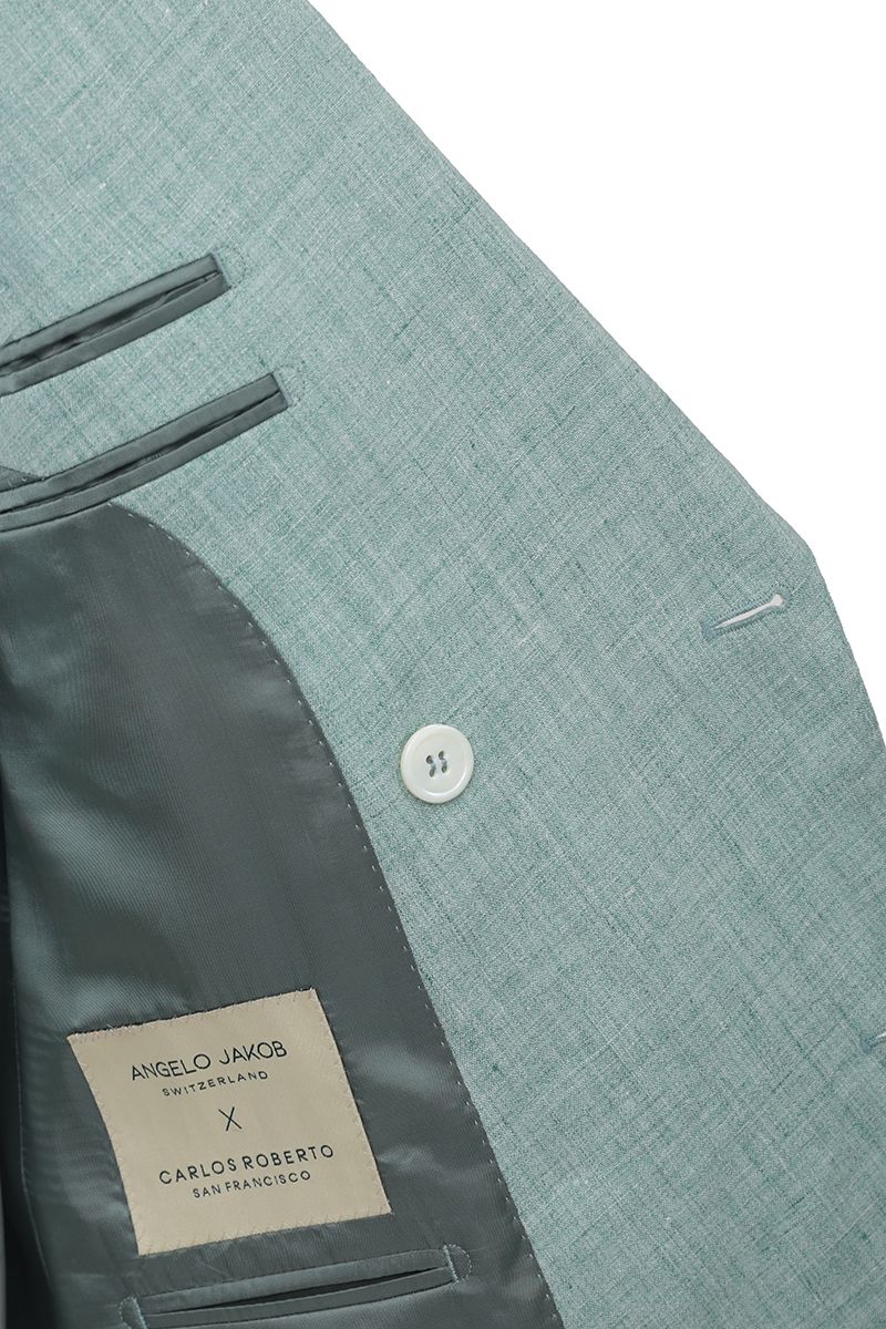 Studio portrait of the Nico Sage Green Double Breasted Linen Sport Coat, a made-to-order men's peak lapel jacket in sage green 100% Italian Guabello linen, shipped nationwide by Zane.