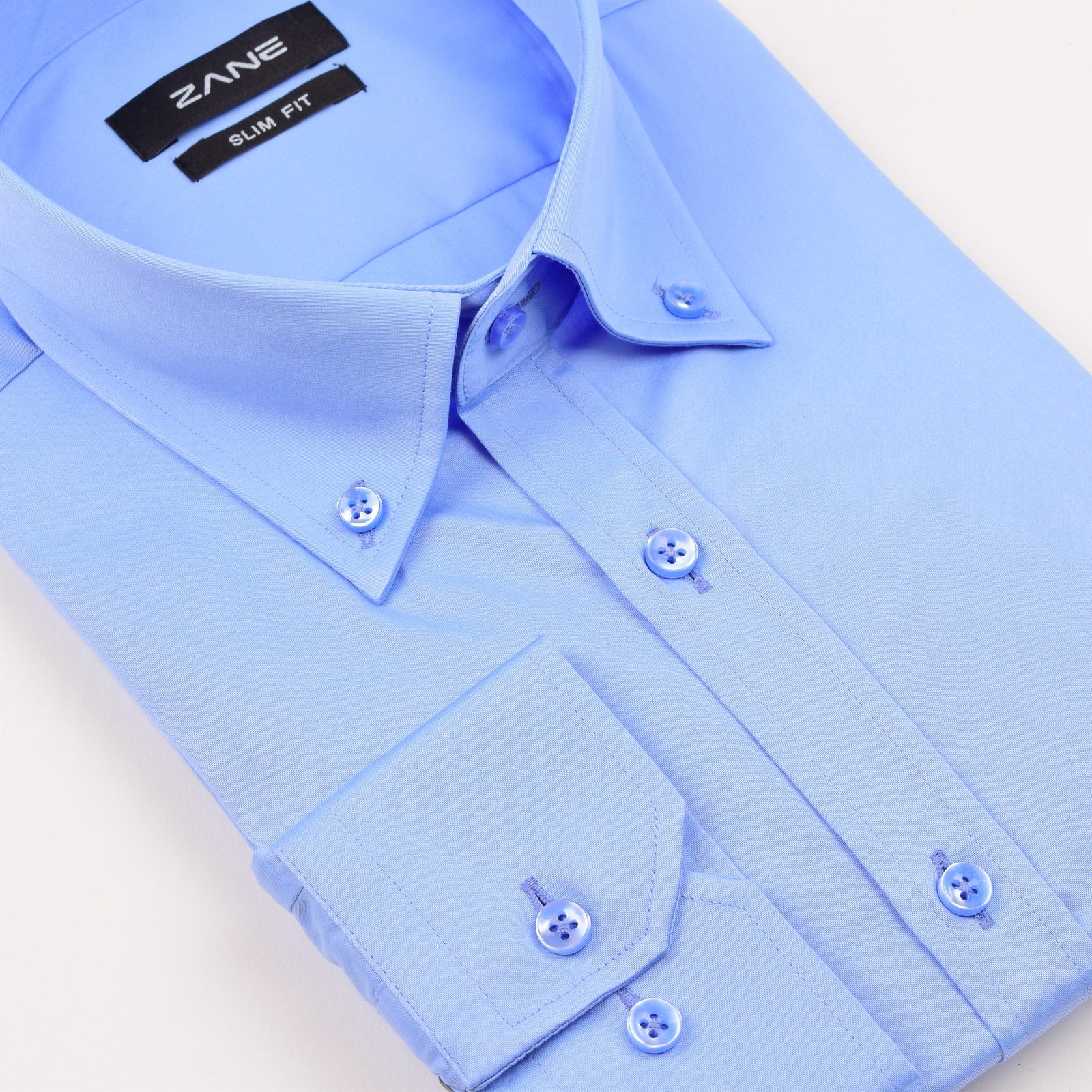 A blue button-down collar shirt with long sleeves and a lightweight feel, made from premium cotton. Essential blue button down slim fit dress shirt mens long sleeve cotton business casual shirt Jacksonville formalwear Zane Suits and Tuxedos