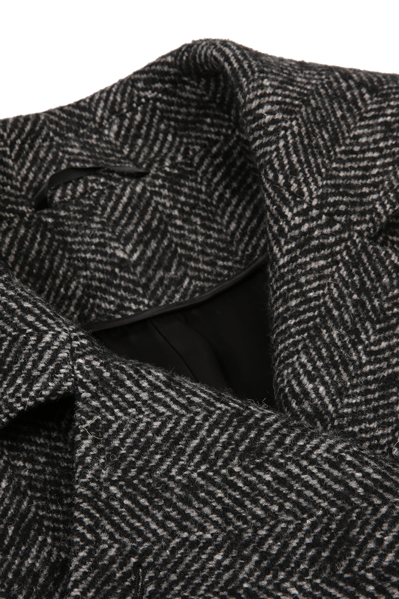 Close-up of a textured gray coat with a herringbone pattern.