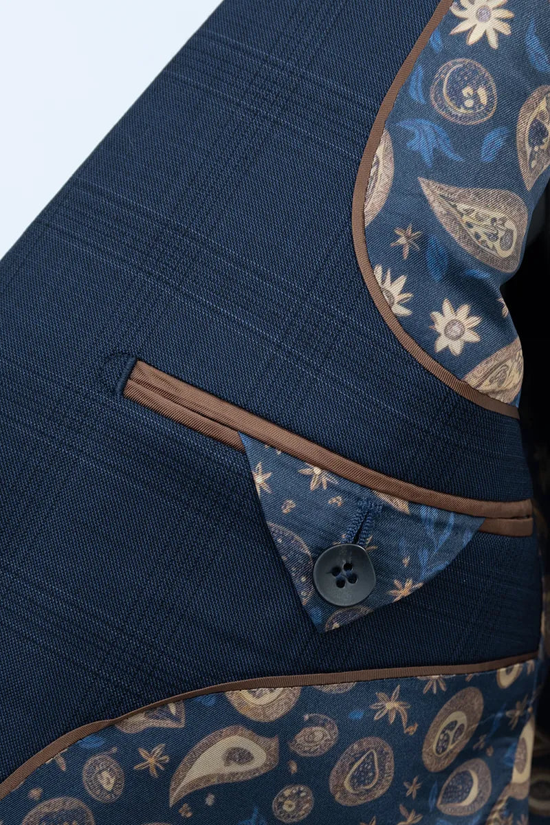 Close-up of a blue fabric with paisley patterns and a button best suits in Carolina 