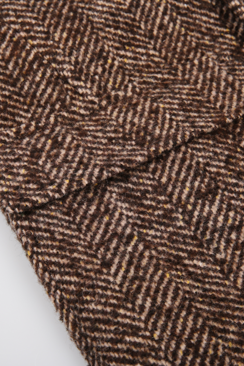 Close-up of brown herringbone pattern fabric custom made to measure suits overcoats 