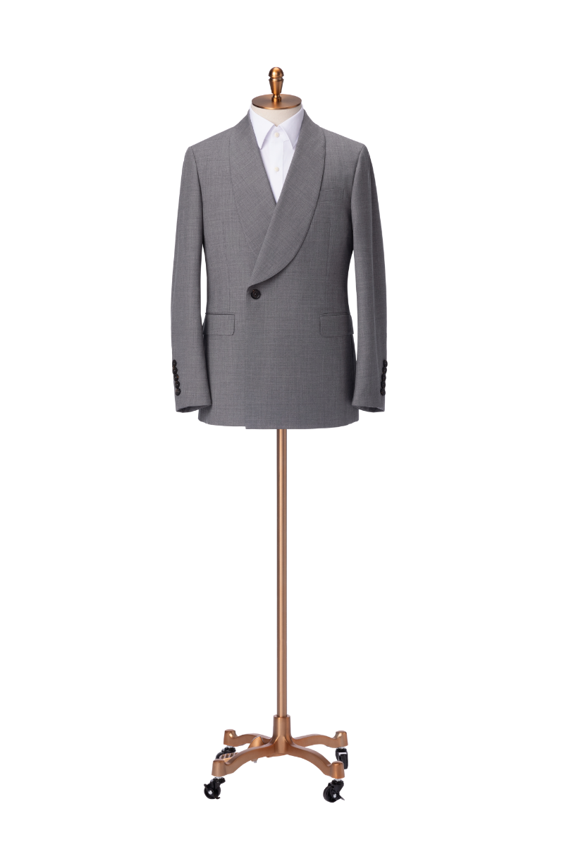 Elegant men's light gray blazer crafted from 100% wool, featuring a distinctive shawl lapel design, single-button front closure, structured shoulders, and tailored fit for formal occasions. Displayed on a mannequin stand, this sophisticated blazer is ideal for business professionals, weddings, evening events, and upscale gatherings. Perfectly pairs with dress pants, formal shirts, and accessories for a complete polished look, showcasing luxury men's formalwear and timeless fashion style.