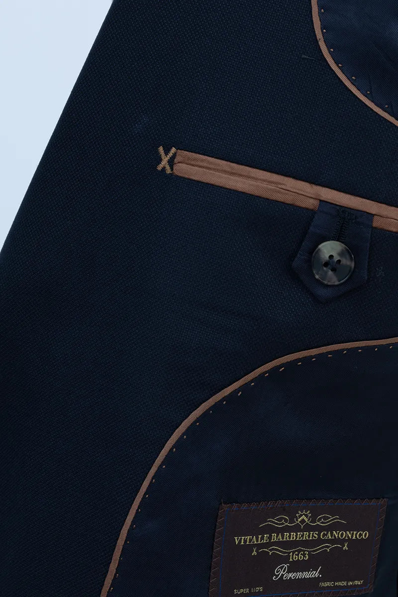 Navy blue apron with a brand label on a light blue background italian vbc suit 