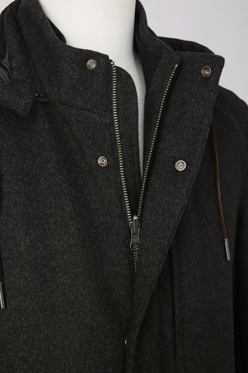 Dark gray coat with a zipper on a mannequin against a white background